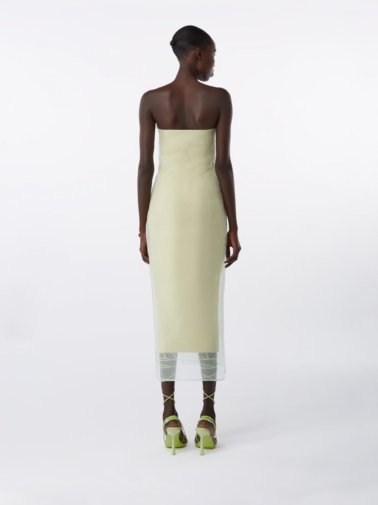 model wearing a pale olive strapless dress with veil