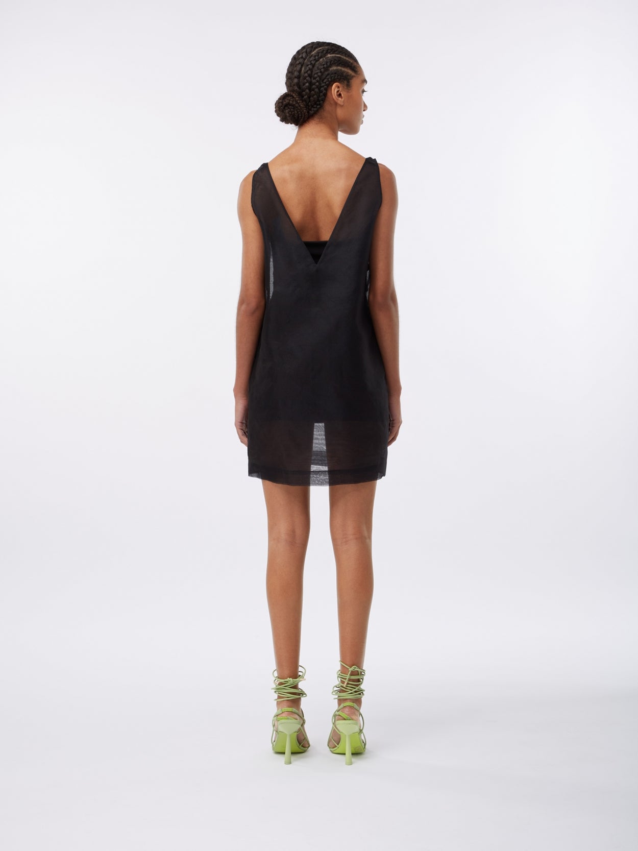 model wearing a black mesh overlay dress