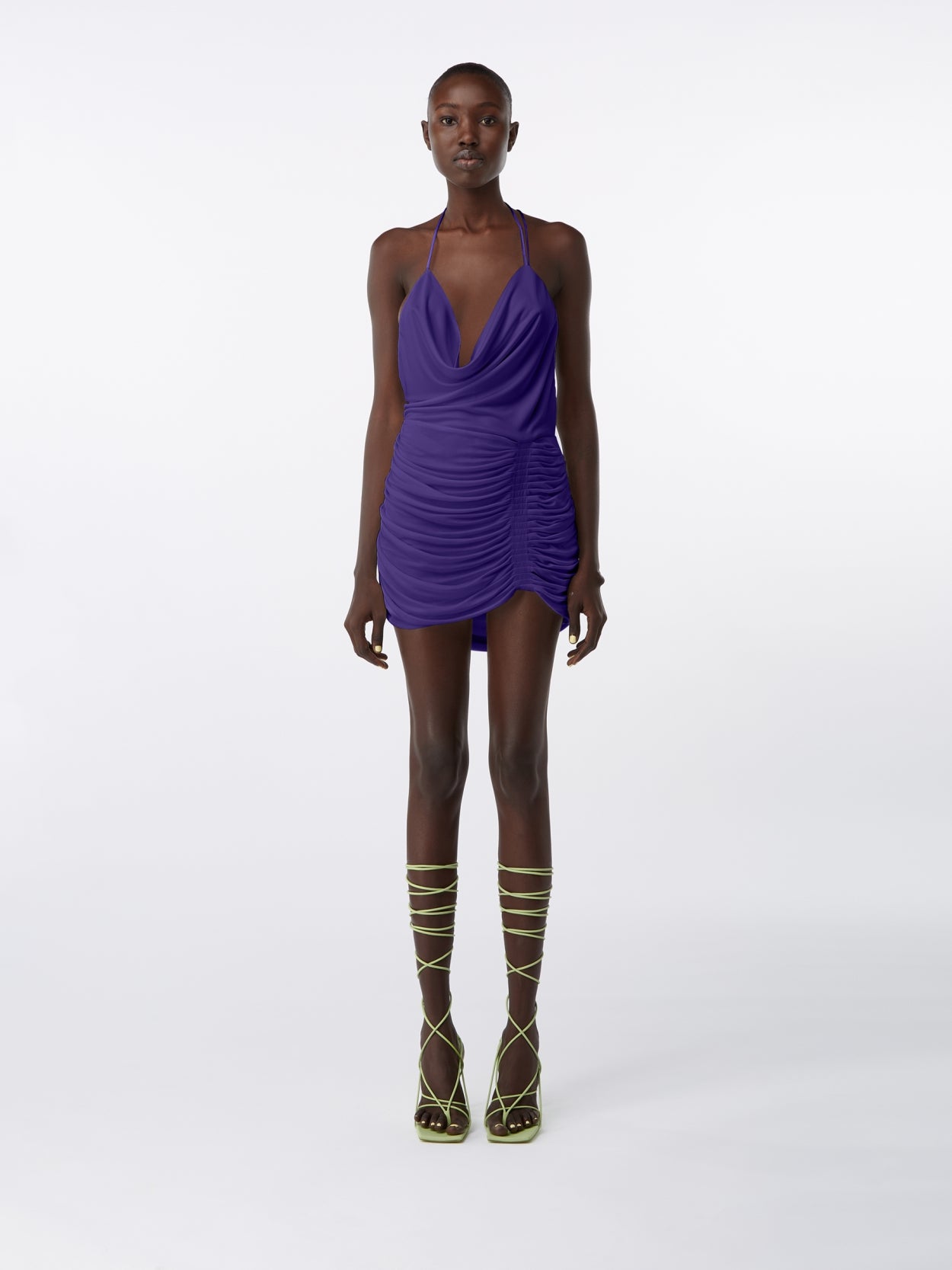 model wearing purple halter neck mini dress with  open back