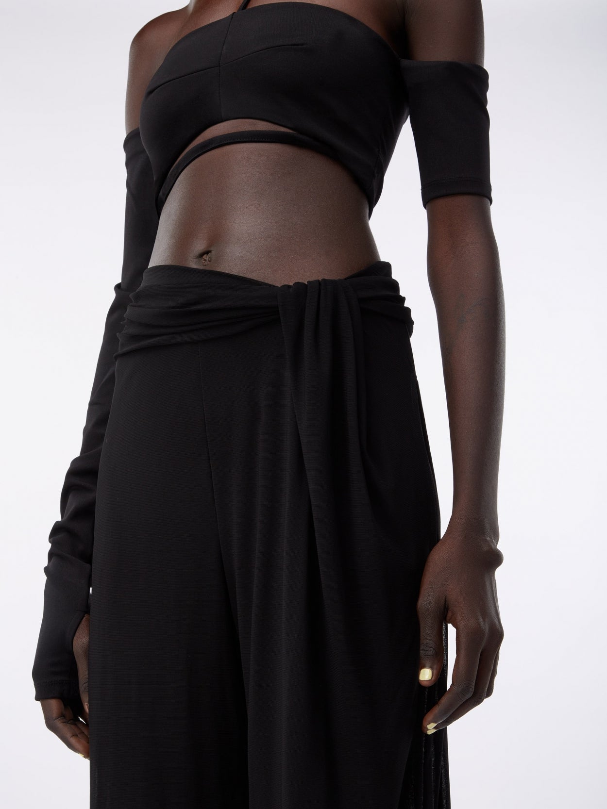detail of black draped trousers with twist detaill