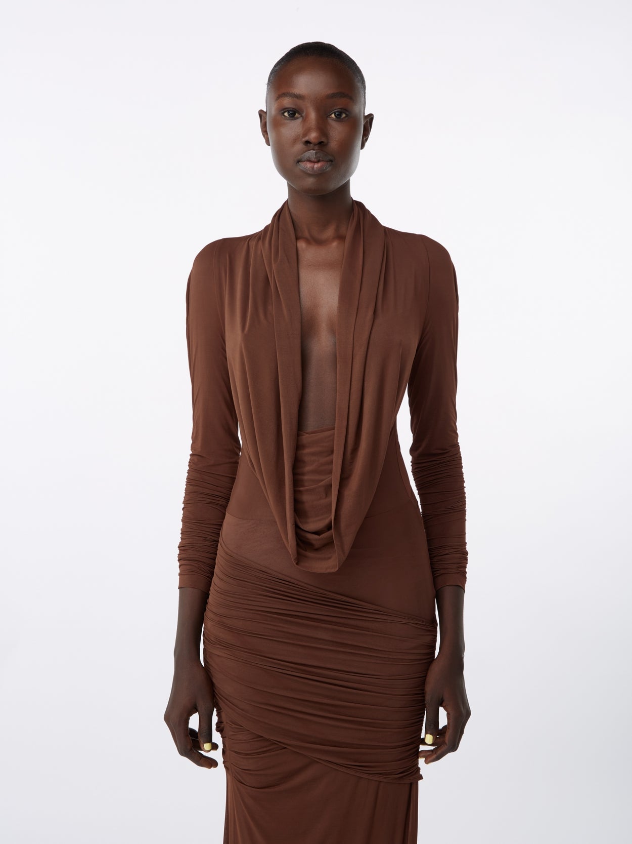 close up of a model wearing a brown hooded jersey draped dress 