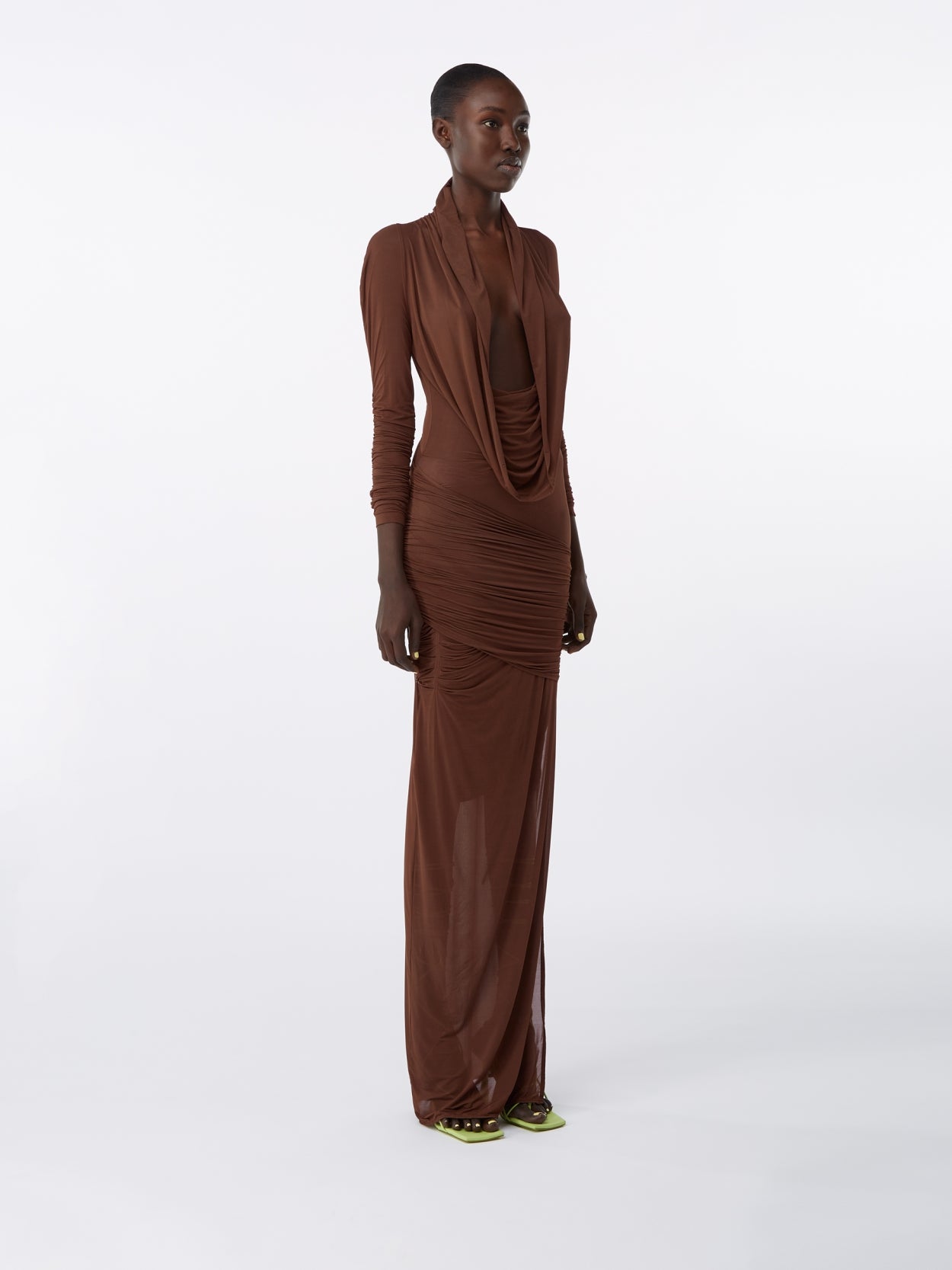 model wearing a brown hooded jersey draped dress 